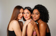 © Barry - Three young, diverse, beautiful female models, posing together, isolated on a white background.
