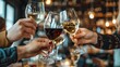 © Dinara - A group of friends are toasting with glasses of red and white wine in a restaurant. They are all smiling and enjoying their time together.