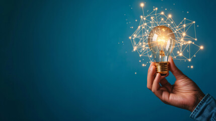 Aufkleber - Hand holds a glowing light bulb against a blue background, with digital network lines