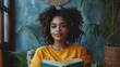© Janko - A relaxed and content young woman with curly hair reads a book sitting in a peaceful, plant-filled room