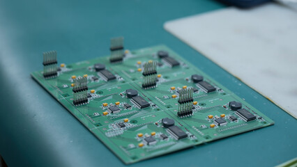 Poster - Young man repairing computer components in service center. Creative. Close up of soldering the chip.