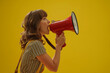 © gearstd - Girl shouting through a red megaphone