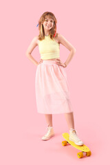 Sticker - Young woman with skateboard on pink background