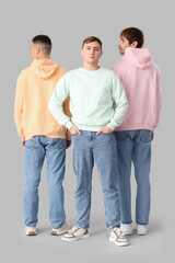 Poster - Young men in stylish jeans on light background