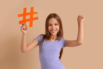 cute teenage girl with hashtag on beige background