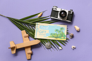 Sticker - Composition with travel gift voucher, photo camera, palm leaf and wooden plane on color background