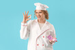 © Pixel-Shot - Female chef with tampons on blue background