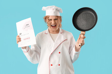 Wall Mural - Angry female chef with menstrual calendar and frying pan on blue background