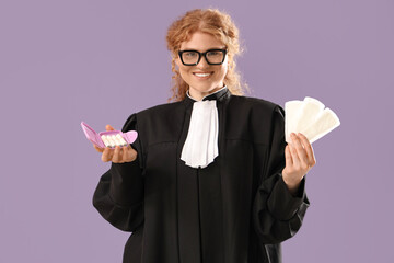 Wall Mural - Female judge with menstrual pads and tampons on violet background