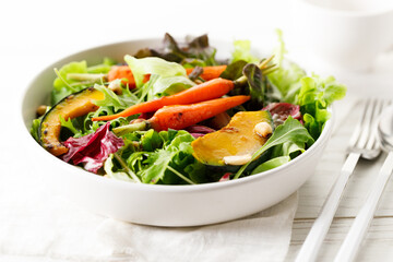 Wall Mural - Green salad with grilled carrot, roasted pumpkin and green leaf.