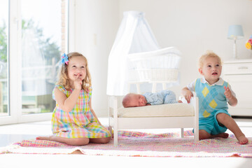 Wall Mural - Kids play with newborn baby brother