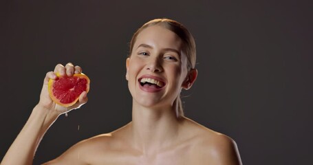 Poster - Grapefruit, squeeze and portrait of woman with skincare for natural beauty, vitamin c and cosmetics in studio. Dermatology, fruit and girl with confidence, smile or healthy skin on dark background.