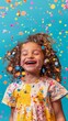 © Lisicus - happy child girl with confetti on blue background