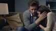 © vefimov - A man and woman are sitting on a couch, the man is crying and the woman is comforting him
