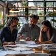 © Thares2020 - Architects Collaborating Over Blueprint in Modern Office Setting for Team Concept
