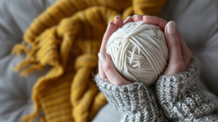 Wall Mural - Woman's hand holding a ball of thread for weaving