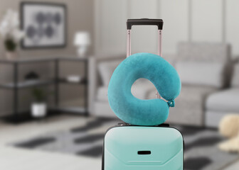 Sticker - Travel pillow on suitcase in room. Space for text