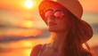 © JERSH - Portrait of a young woman wearing sunglasses and a straw hat, with her face bathed in the warm glow of a golden sunset, embodying the essence of summer relaxation