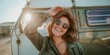 © Armin - A woman, joyous and carefree, with sunglasses and short hair, leans against a green camper van at sunset, embodying a spirit of adventure and freedom.