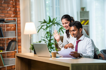 indian asian young ceo businessman working with female colleague in the office using laptop computer