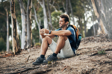 Wall Mural - Man, hiking and happy with smartphone in forest for browsing internet, networking and social media. Fitness, survival and workout in woods on countryside with texting, message and chat on break