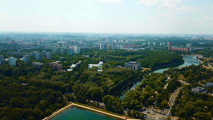 Wall Mural - Top view of city with dam and river on sunny summer day. Creative. Beautiful green city with dam and canal on summer day. Skyline of modern city with green parks and clear canal