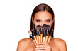 © deagreez - Close up portrait of brunette hair leisure lifestyle good-looking lovely pretty lady with her make up brushes naked shoulders she look at camera hide face isolated on pastel beige background