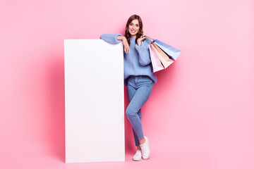 Sticker - Full size photo of charming cheerful girl hold boutique bags huge empty space panel isolated on pink color background