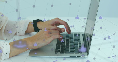 Poster - Image of network of digital icons spinning over mid section of a woman using a laptop at office