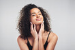 © peopleimages.com - Portrait, woman and studio in relax for skincare, beauty and cosmetic on white background. Curly hair, cosmetology and facial treatment with collagen for model person, hands or texture for haircare