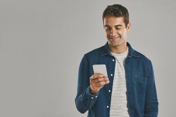 Poster - Studio, man and smartphone with laugh, funny news and comedy with contact by mockup. Creative worker, networking and typing on mobile app with humor, chatting and connection by white background