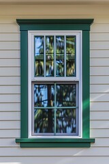 Aufkleber - A white house with a green window and green trim. Suitable for real estate or home improvement concepts