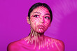© VISTA by Westend61 - Beautiful young woman with light pattern on face against pink background