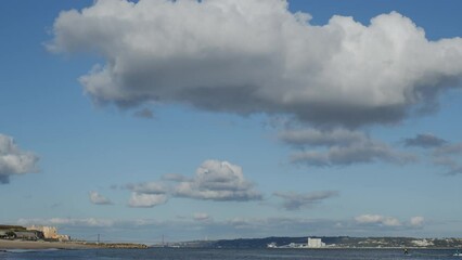 Wall Mural - beautiful cumulus clouds on a blue sky - time lapse video, slow movement of white clouds across the 