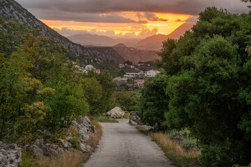 Wall Mural - a scenic road in dalmatia with a view of the sunrise over the biokovo mountain massif