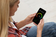© New Africa - 5G speed test. Woman using mobile phone at home, closeup