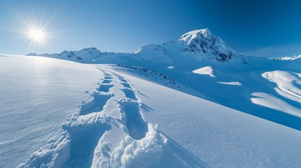 Wall Mural - A mountain top covered in snow with a beautiful sunset in the background