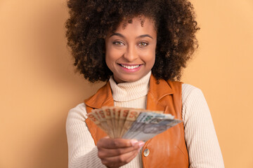 Wall Mural - fun african american woman celebrating successful business Brazil money in studio shot. business, loan, pay, wealth concept. 