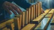 © AI Lab - Close up of businessman hand Stopping Falling wooden Dominoes effect from continuous toppled or risk strategy and successful intervention concept for business : Generative AI