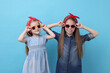 © New Africa - Cute little sisters on light blue background