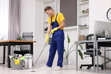 Canvas Print - Cleaning service. Man washing floor with mop in office