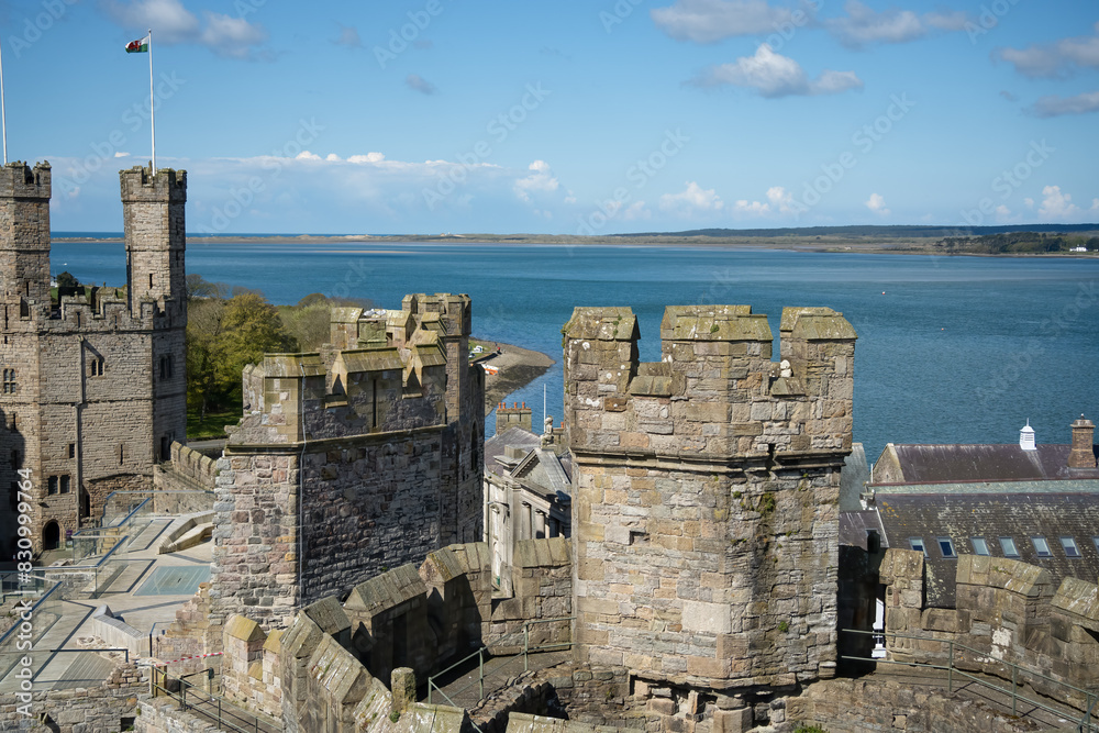stones, walls and towers of Caernarfon Castle, a medieval fortress in ...