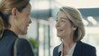 © AI Lab - Happy mature businesswoman and her female coworker communicating while going through the office : Generative AI