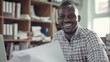 © AI Lab - African small business owner smiling with paperwork and laptop : Generative AI