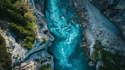 Wall Mural - A vertical aerial view showcasing the surface of a flowing mountain river