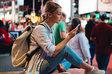 Wall Mural - young woman reading message on mobile phone using internet in roaming during trip to new york, femal