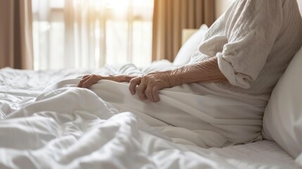 Wall Mural - old woman in white clothes lying in her bed