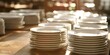 © ANNY - many white plates on the table, blurred background