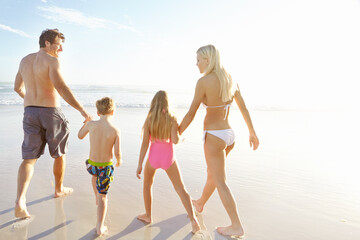 Wall Mural - Back, holding hands and sky with family on beach, walking together in summer for bonding or fun. Love, nature or smile with mother, father and kids on sand by ocean or sea for holiday and vacation