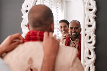 Smile, mirror and Indian man at traditional wedding, clothes and getting ready for celebration in home. Happy, friends and people with marriage ceremony, support and fashion culture in reflection.